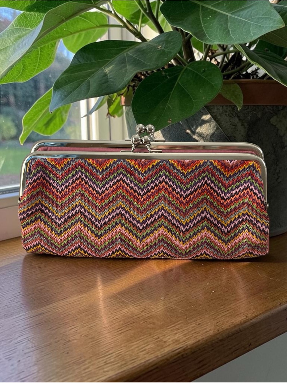Christopher & Banks clutch features a vibrant multi-color chevron pattern.